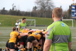 A referee and linesman look on