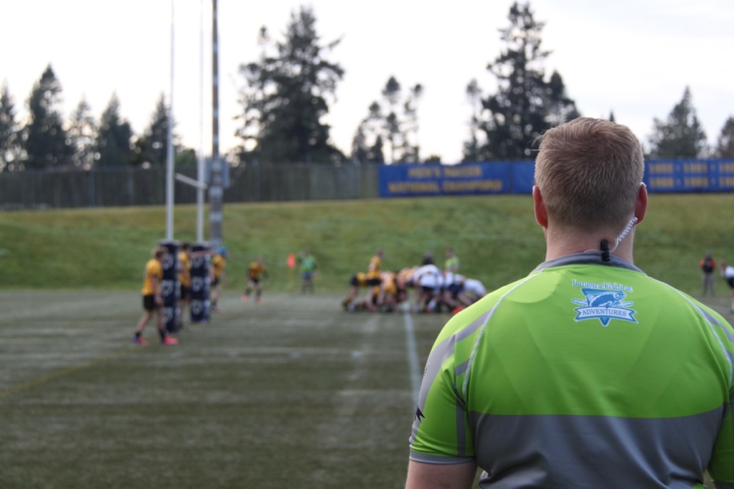 A referee looks on at a scrum