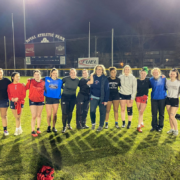 A group of female rugby players pose for a photo after training