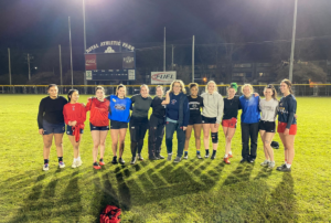 A group of female rugby players pose for a photo after training
