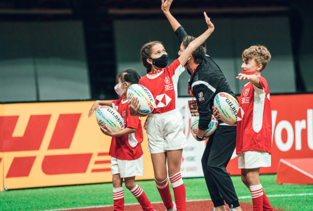 HSBC Canada Sevens Ball Carrier children wave on the pitch at BC Place