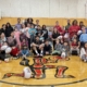 Rugby Canada players pose with a group of Indigenous children in a gym