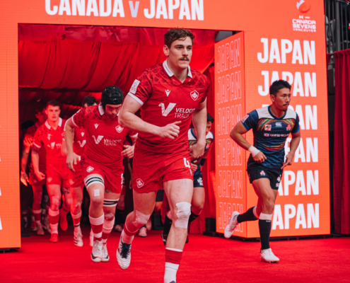 Canada and Japan Rugby Players run out onto the BC Place pitch through a big red entrance
