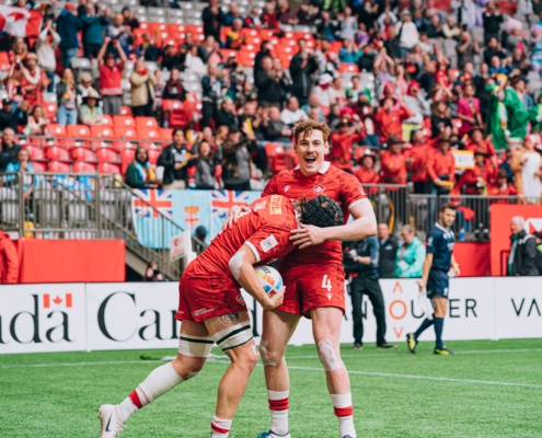 Rugby Canada player Phil Berna celebrates with Jake Thiel