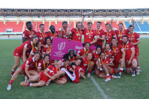 Canada's Men's and Women's Sevens teams celebrate together with a group photo on the pitch of a stadium