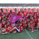 Canada's Men's and Women's Sevens teams celebrate together with a group photo on the pitch of a stadium