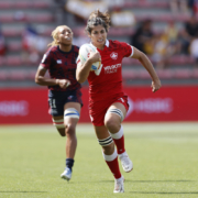A Rugby Canada female athlete runs with the ball in Toulouse