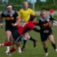 A Canada West Selects player evades a tackle while carrying a Rugby ball