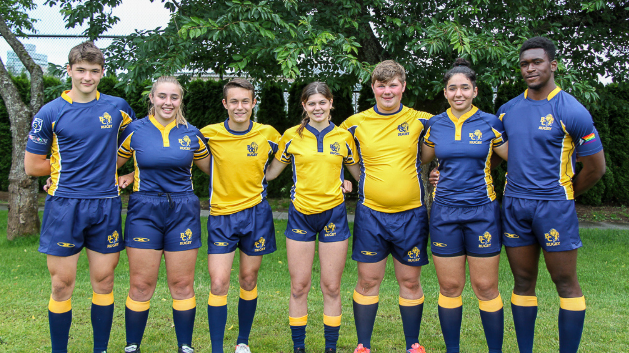 Four male and three female players model the new navy and gold BC Bears kits