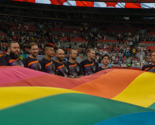 The Vancouver Rogues present a Pride flag on the middle of the field at BC Place