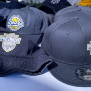 A collection of navy hats for sale with the 2022 Provincial Regional Championships logo