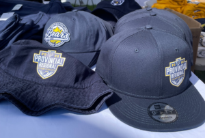 A collection of navy hats for sale with the 2022 Provincial Regional Championships logo
