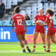 Canada players gather the ball after a try scored during the Women's Rugby World Cup 7s