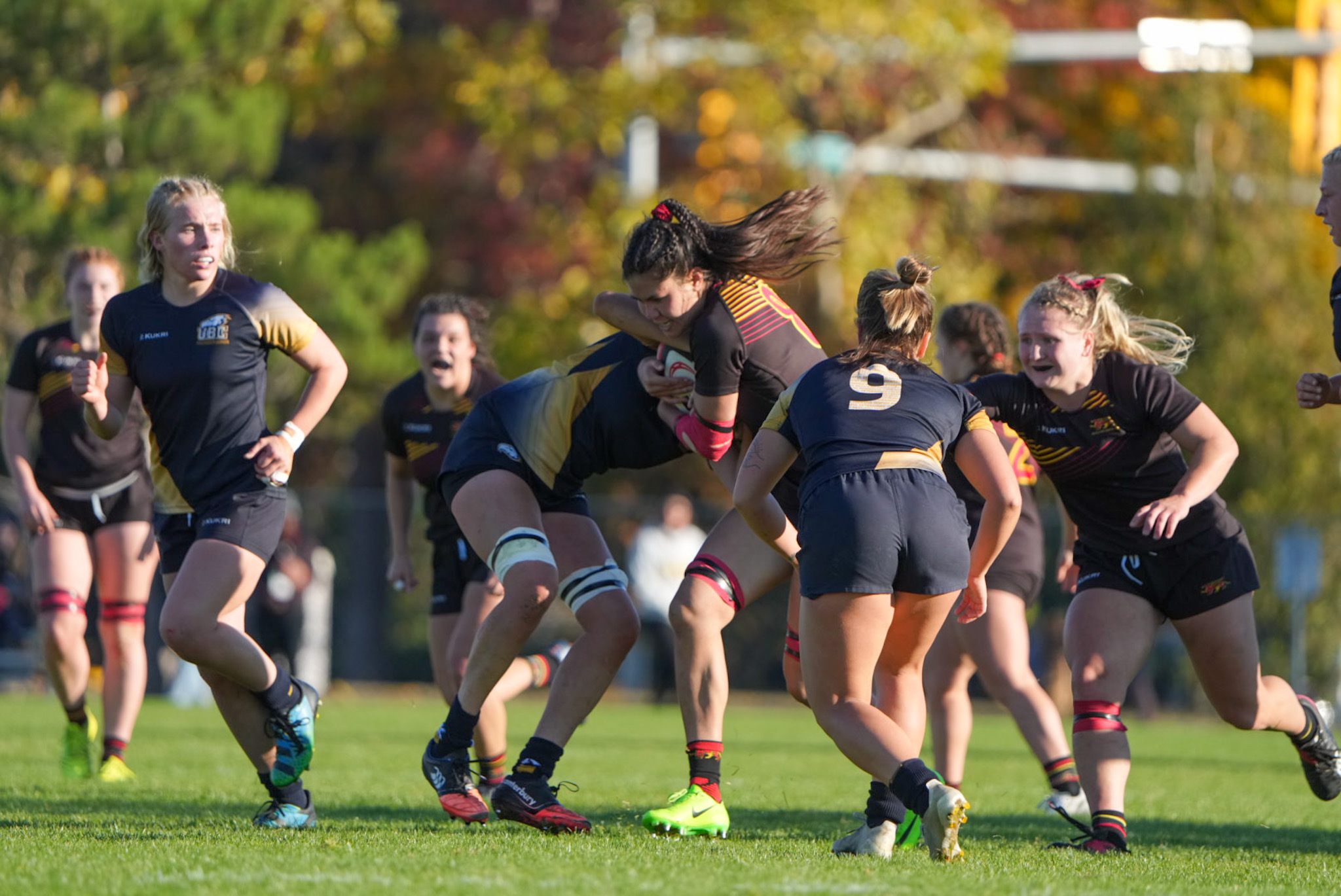 Two UBC players tackle a Guelph Gryphons player at the 2022 U SPORTS Women's Rugby Championship