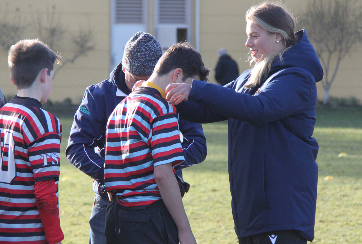 Canada captain Sophie de Goede presents medals at the 2022 BC Rugby Age-Grade Finals