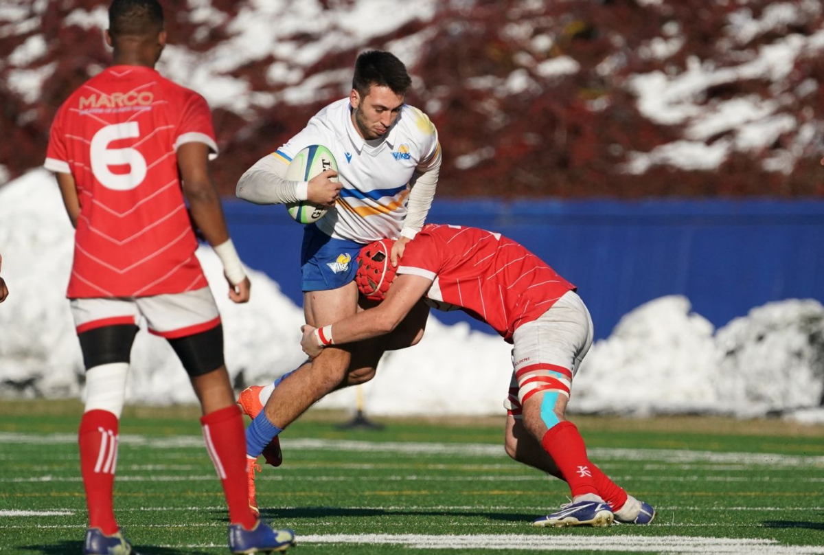A University of Victoria Vikes player riders a challenge at the 2022 Canadian University Men's Rugby Championship