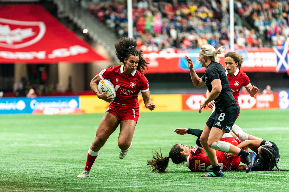 A Canada Women's Sevens player runs with the ball against New Zealand at BC Place