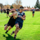 A Port Alberni player tackles a UBCOB Ravens player during the 2023 BC Rugby Senior Club Finals