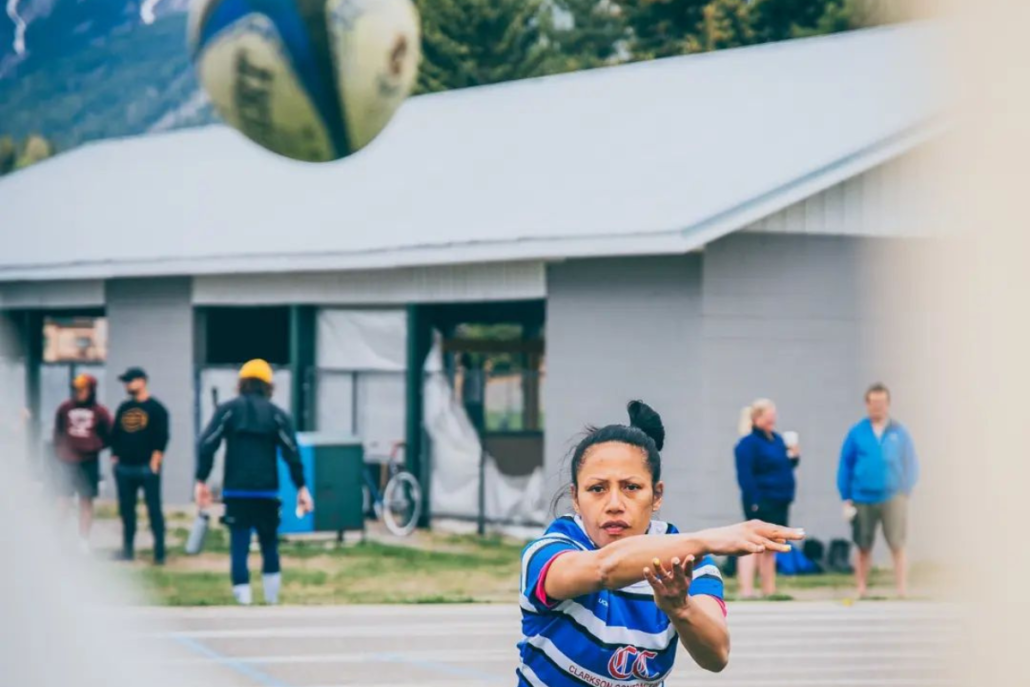 An Elk Valley RFC Women's player throws the ball at a camera