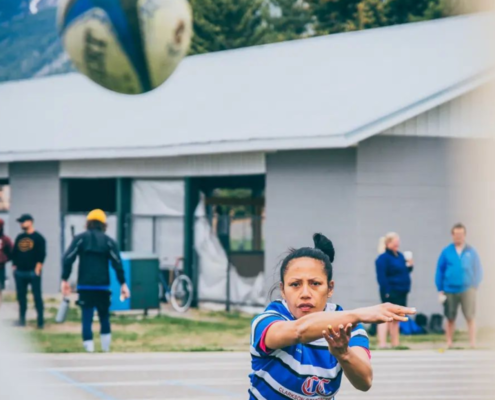 An Elk Valley RFC Women's player throws the ball at a camera