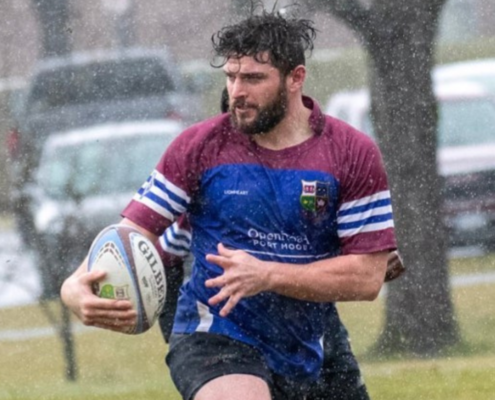 A United RFC Men's player carries the ball during a match