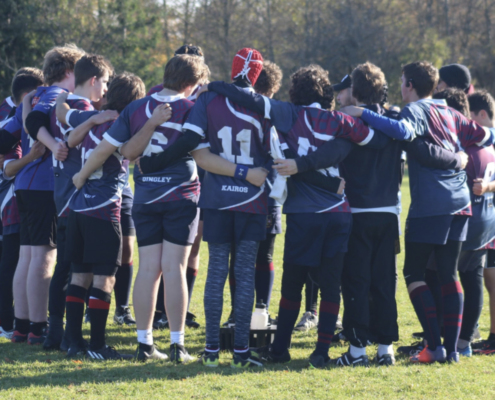 United RFC Boys huddle on the pitch before a match