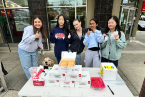 StrongHer Society selling donuts as a fundraiser